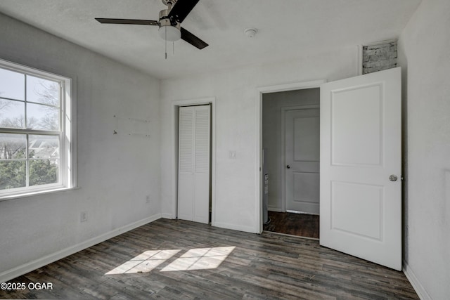 unfurnished bedroom featuring a closet, a ceiling fan, baseboards, and wood finished floors