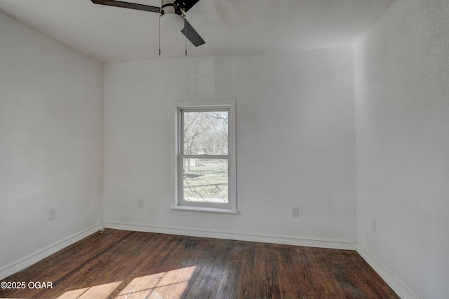 empty room with ceiling fan, baseboards, and wood finished floors