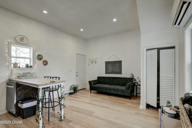 interior space featuring recessed lighting, light wood-style floors, and a wall mounted AC