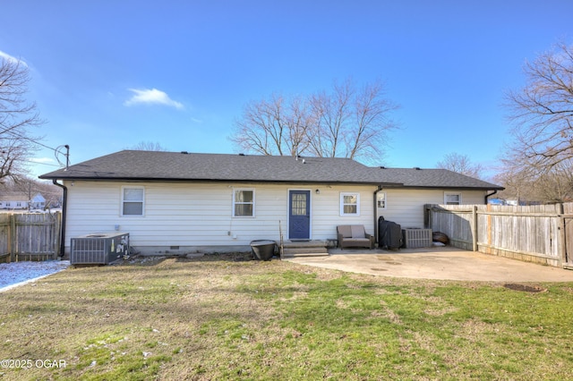 back of house featuring central air condition unit, a lawn, fence, crawl space, and a patio area