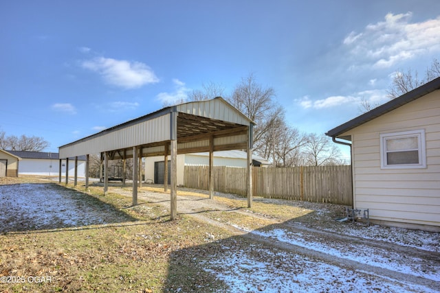 view of yard with a carport and fence