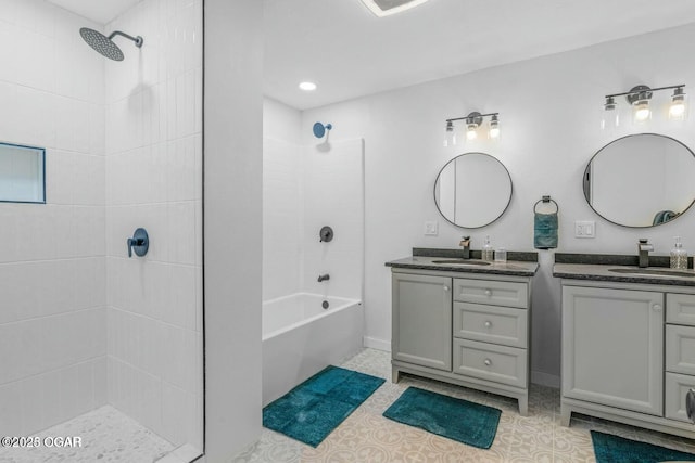 bathroom featuring tile patterned floors, tub / shower combination, two vanities, and a sink