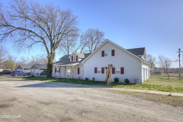 view of front of home with a garage, driveway, and fence