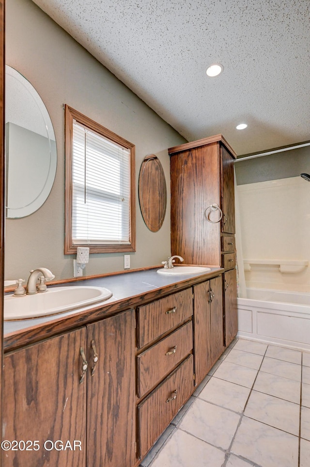 full bathroom with a sink, recessed lighting, double vanity, and tile patterned flooring