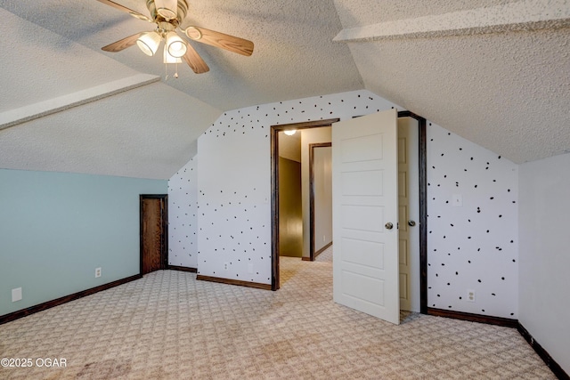 additional living space with baseboards, a textured ceiling, carpet flooring, and vaulted ceiling