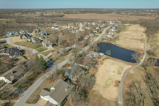 drone / aerial view with a residential view and a water view