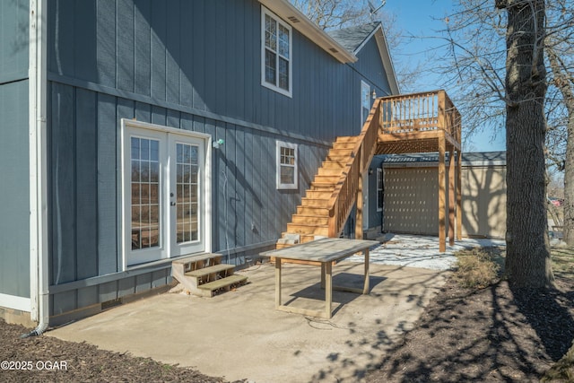 rear view of property featuring a patio area, entry steps, and stairs