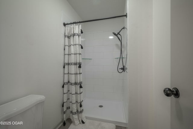 full bathroom with toilet and a stall shower