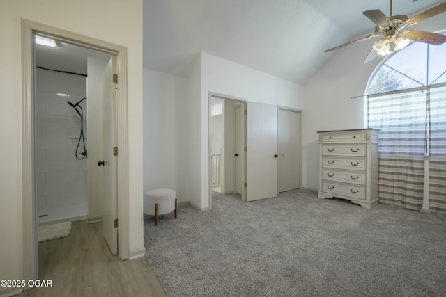 unfurnished bedroom featuring light colored carpet, ceiling fan, and vaulted ceiling