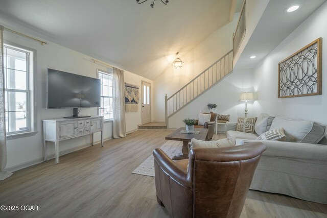 living area with stairs, recessed lighting, wood finished floors, and baseboards