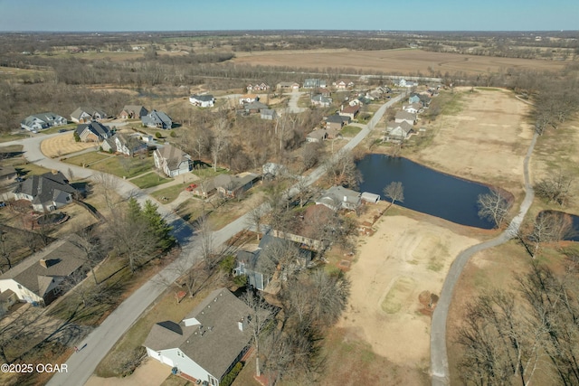 drone / aerial view featuring a residential view and a water view