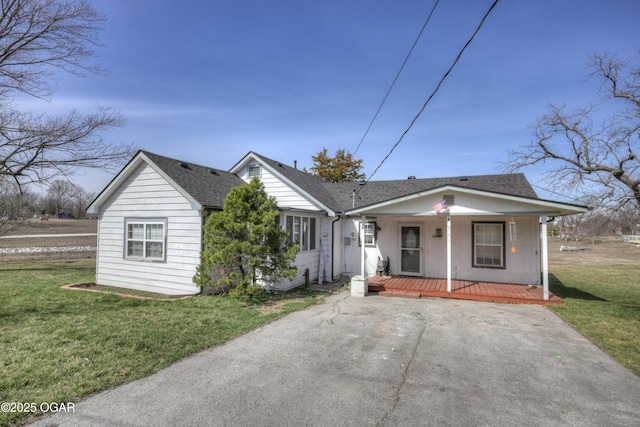 bungalow-style home featuring roof with shingles, covered porch, and a front lawn