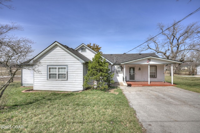 bungalow featuring a front lawn, covered porch, and a shingled roof