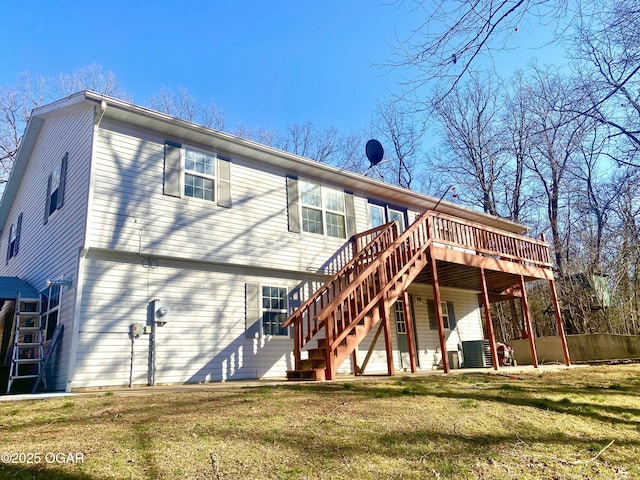 rear view of house with a lawn, central AC, stairs, and a deck