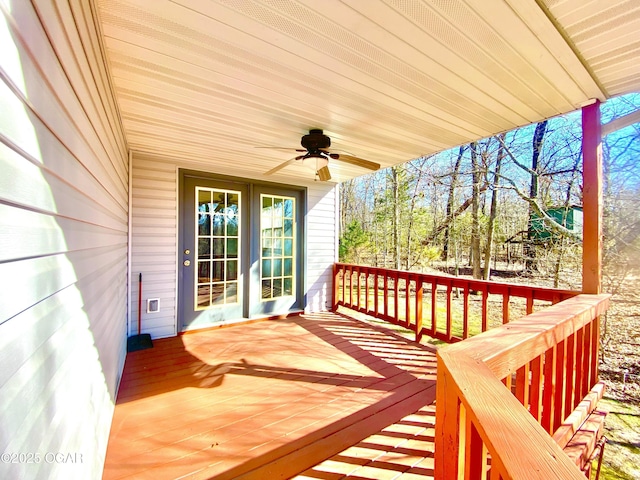 deck with french doors and a ceiling fan