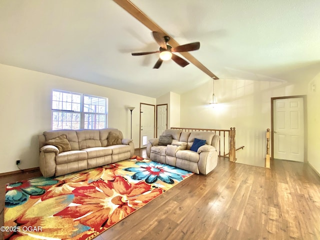 living area featuring a ceiling fan, vaulted ceiling with beams, wood finished floors, and baseboards