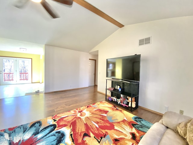 living area featuring lofted ceiling with beams, wood finished floors, visible vents, and baseboards