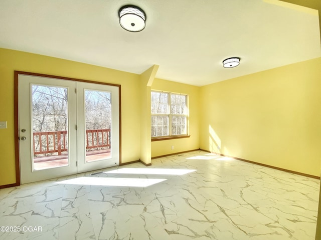 entryway featuring baseboards and marble finish floor