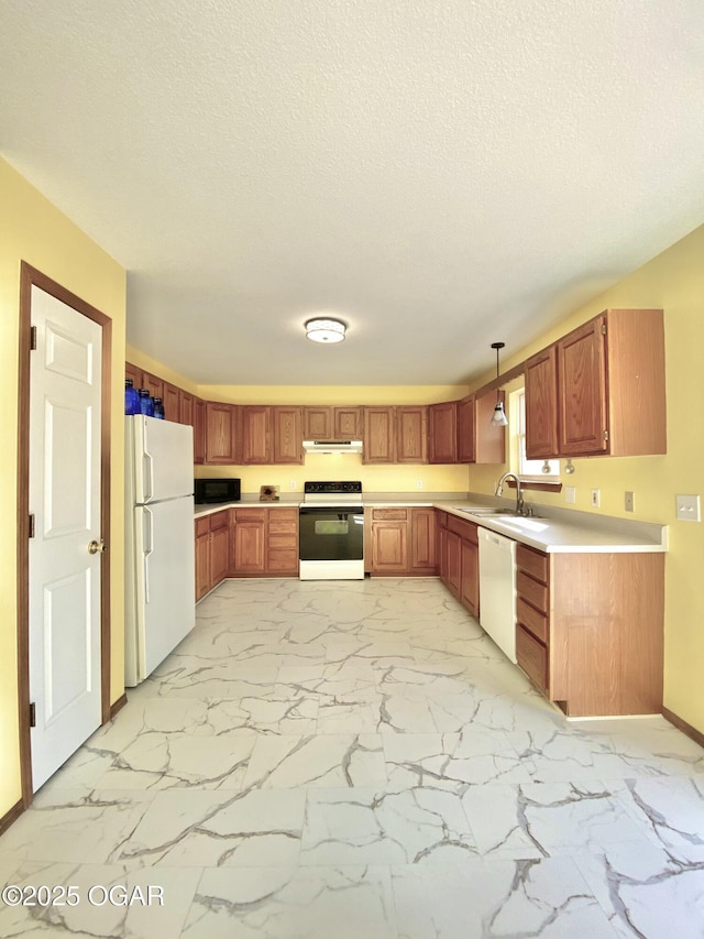 kitchen with white appliances, a textured ceiling, marble finish floor, and light countertops