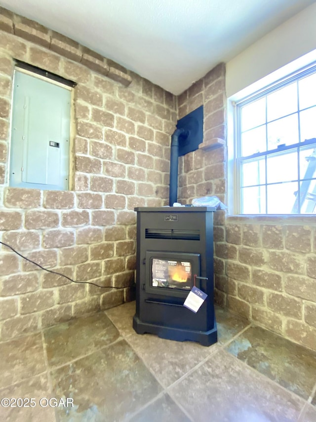 details featuring electric panel and a wood stove