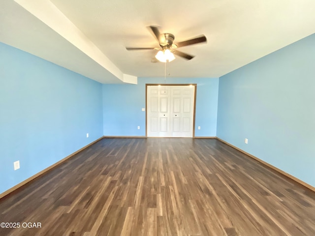 unfurnished bedroom with a closet, ceiling fan, baseboards, and wood finished floors