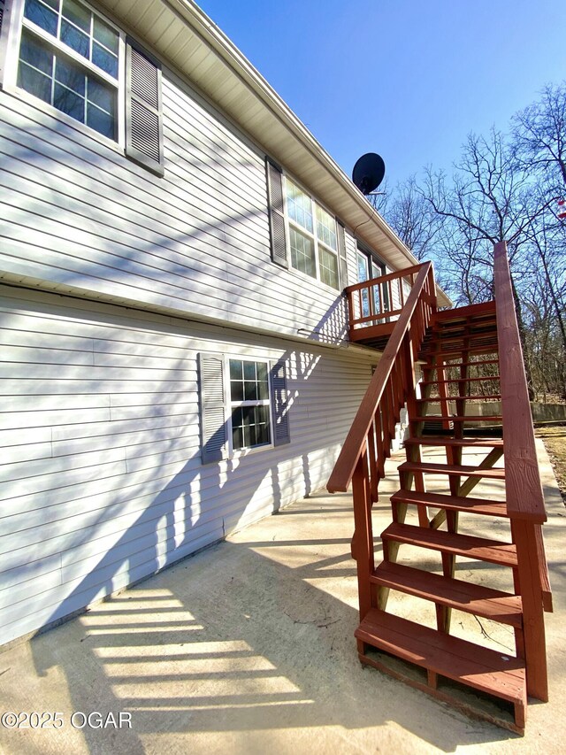 doorway to property with a deck and a patio