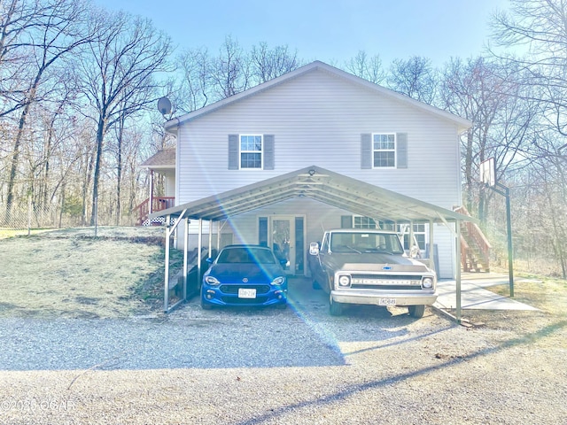 view of front of home with gravel driveway and stairs