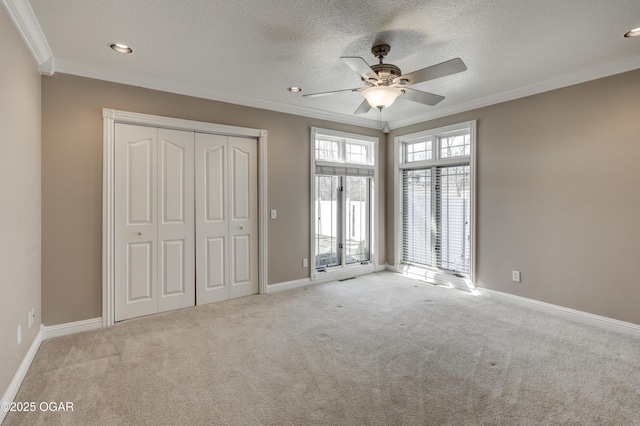 unfurnished bedroom featuring ornamental molding and carpet flooring