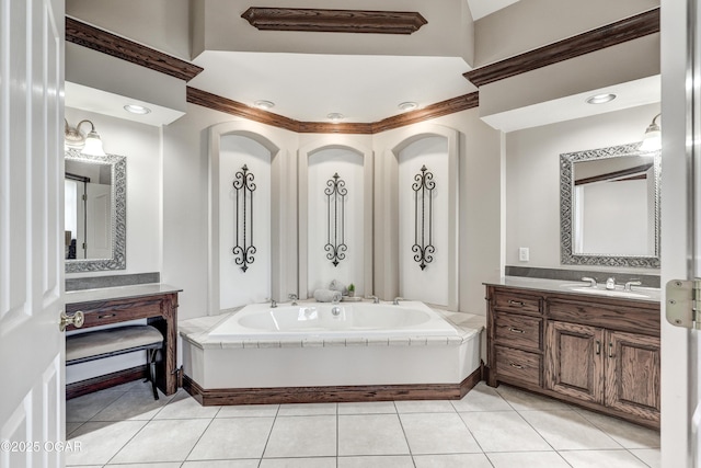 full bathroom with tile patterned floors, a garden tub, and vanity