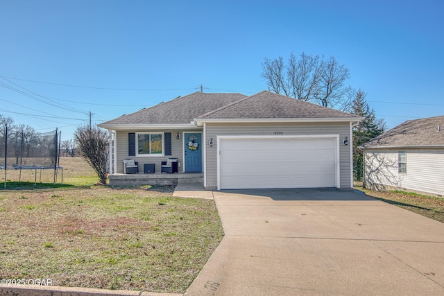 ranch-style home featuring a front lawn, driveway, a trampoline, roof with shingles, and an attached garage