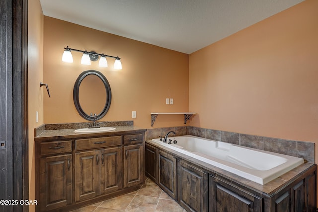 full bath featuring vanity, tile patterned floors, and a garden tub