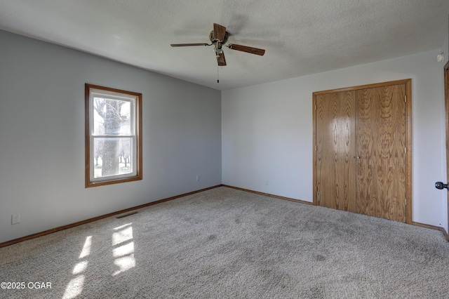 unfurnished bedroom with a ceiling fan, baseboards, visible vents, a closet, and a textured ceiling