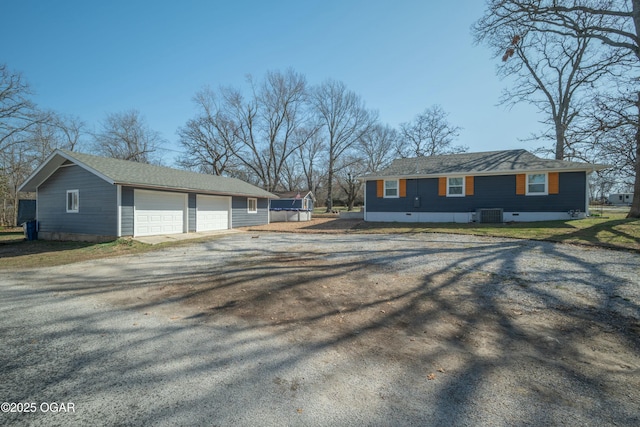 view of side of home featuring an outdoor structure and driveway