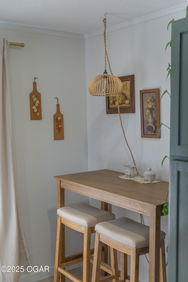 dining space with crown molding