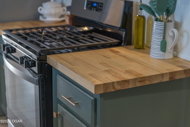 room details featuring butcher block counters and stainless steel range with gas cooktop