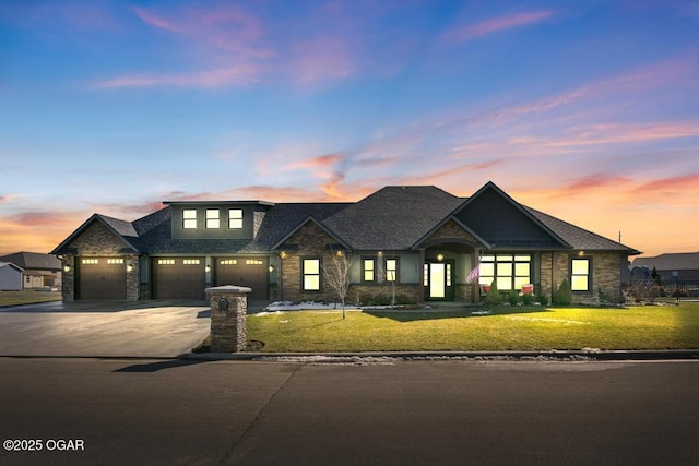 view of front of house featuring concrete driveway, a yard, and a garage