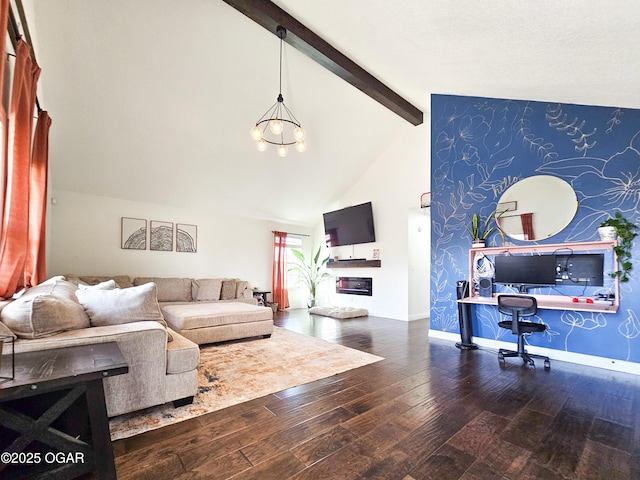 living room with wood finished floors, baseboards, an accent wall, beamed ceiling, and a chandelier