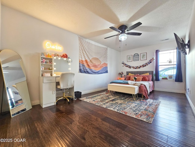 bedroom with visible vents, baseboards, a textured ceiling, and hardwood / wood-style flooring