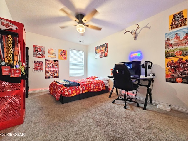 carpeted bedroom with ceiling fan, baseboards, and a textured ceiling