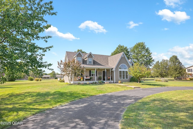 cape cod-style house with covered porch and a front lawn