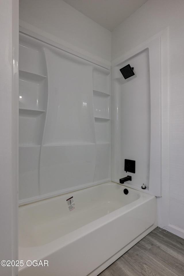 bathroom with shower / tub combination and wood finished floors