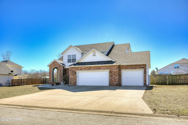 traditional-style house with brick siding, driveway, and fence