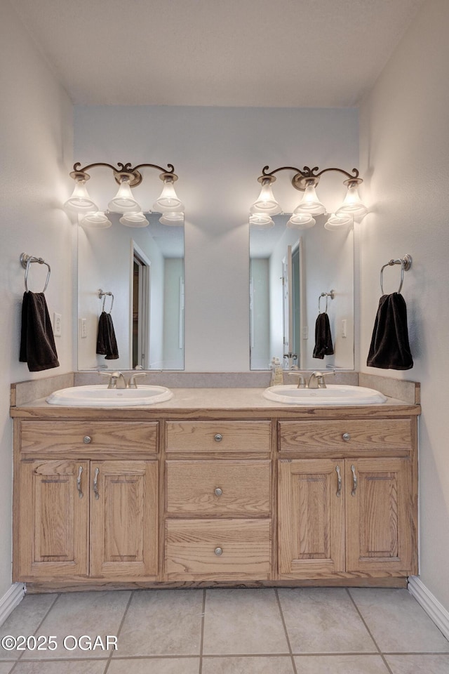 bathroom featuring tile patterned floors, double vanity, and a sink