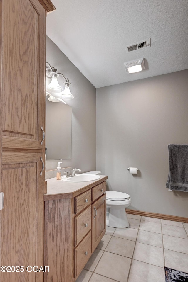 bathroom with vanity, visible vents, a textured ceiling, tile patterned floors, and toilet