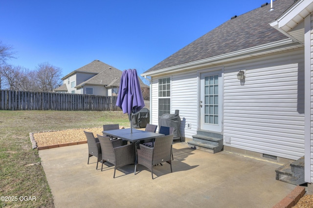 view of patio featuring entry steps, outdoor dining space, and fence