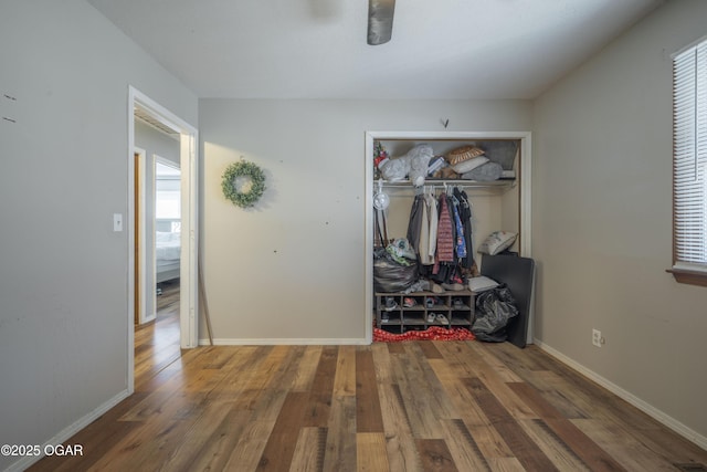 interior space with baseboards and wood finished floors