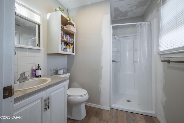 bathroom with curtained shower, backsplash, wood finished floors, and vanity