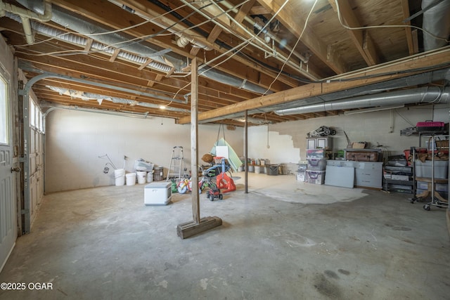 unfinished basement featuring concrete block wall