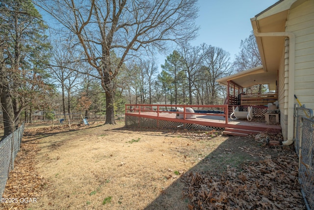 view of yard with a wooden deck and fence