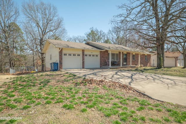 ranch-style home with brick siding, fence, a porch, a garage, and driveway